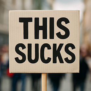 Protest sign that says 'It Sucks'